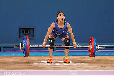 Mirabai Chanu competes during the clean and jerk stage of the women's 49kg weightlifting